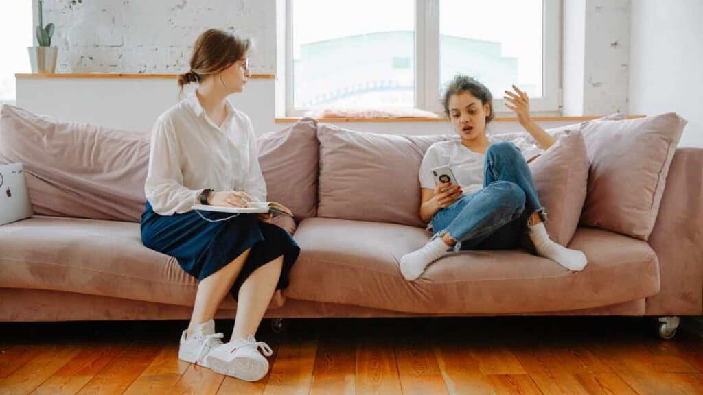 Teen girl in therapy session talking to a counselor, illustrating effective treatment approaches in residential care settings.
